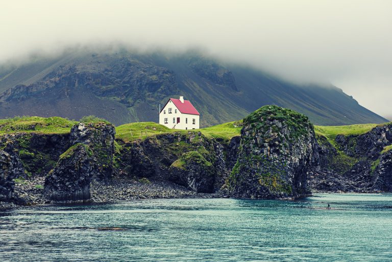 Lonely Icelandic House With Red Roof On The Sea Coast With Green Home